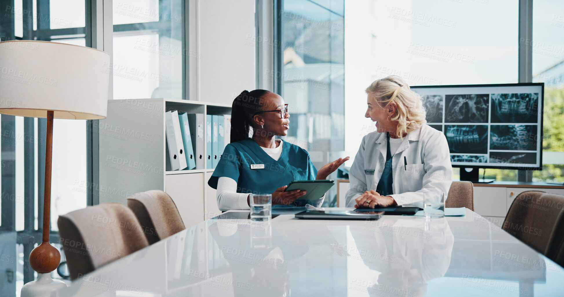 Buy stock photo Discussion, doctor and medical student in hospital with xray for surgery planning in collaboration. Women, conversation and mature surgeon with healthcare intern for teaching treatment with MRI scan.