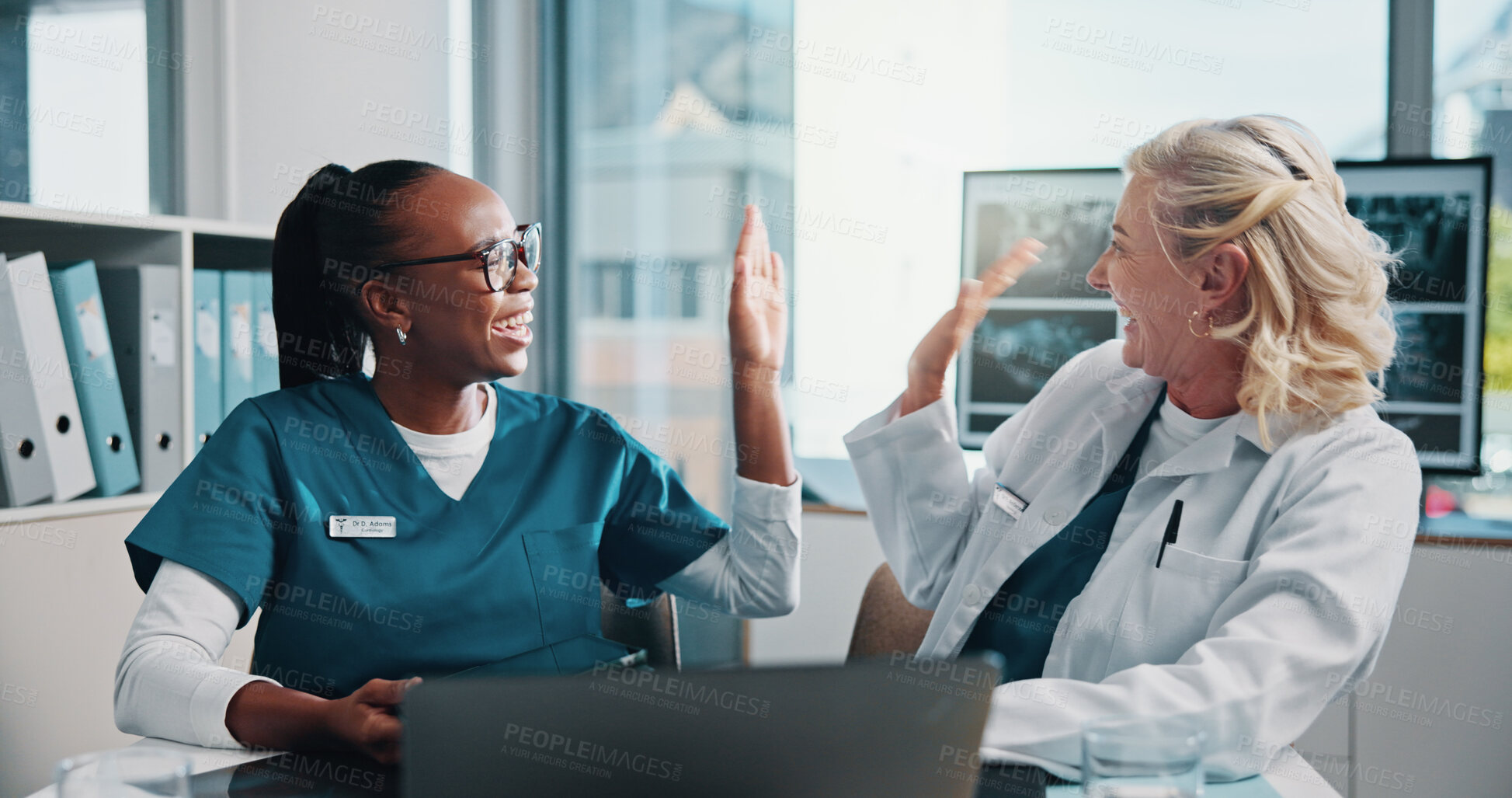 Buy stock photo High five, doctor and medical student in hospital with laptop for surgery planning in collaboration. Women, celebration and mature surgeon with healthcare intern for teaching treatment with computer.