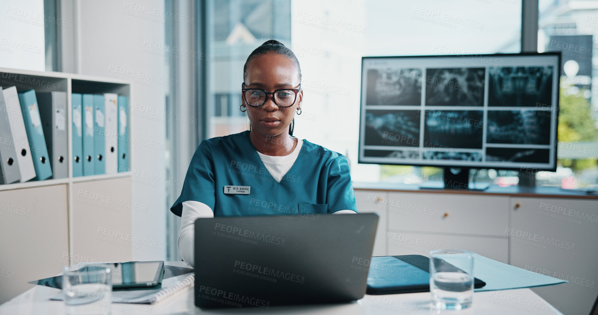 Buy stock photo Black woman, doctor and check laptop at hospital of xray study, lab results and schedule update. Person, online or research for radiology information, medical report and review scan of treatment plan
