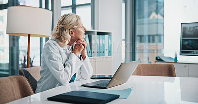 Buy stock photo Doctor, healthcare and laptop with woman thinking in office of hospital for diagnosis, planning or research. Computer, medical and vision with mature professional practitioner at desk in clinic