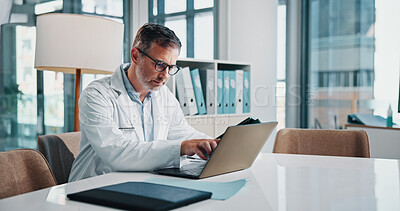 Buy stock photo Healthcare, laptop and report with doctor man at desk in office of hospital for diagnosis, planning or research. Computer, medical and mature medicine professional with pointing or reading in clinic