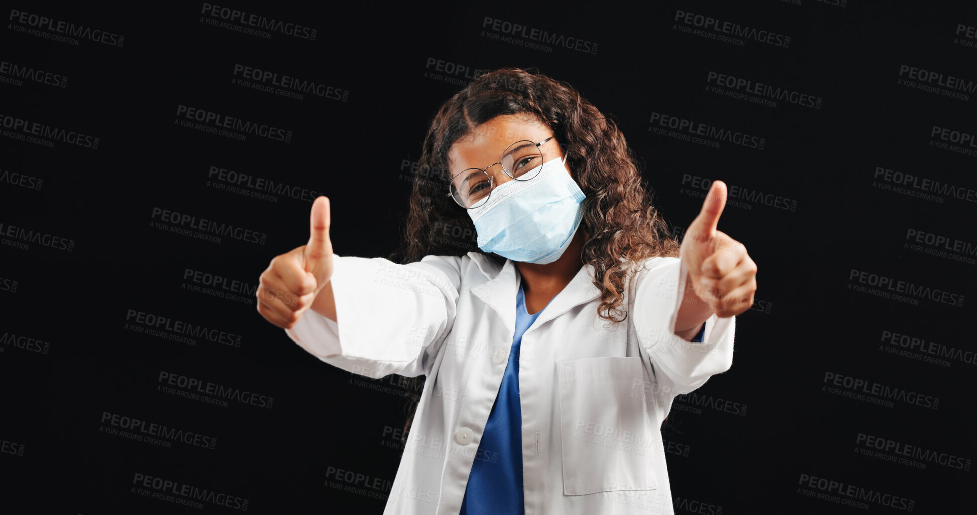 Buy stock photo Portrait, child and thumbs up as doctor with face mask of medical feedback, compliance or agreement. Studio, kid and yes sign and healthcare safety, virus protection and good news on black background