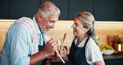 Buy stock photo Singing, cooking and happy senior couple in kitchen for music, retirement celebration and excited for love. Man, woman and song for romance in home, playful karaoke and fun moment with wooden spoon