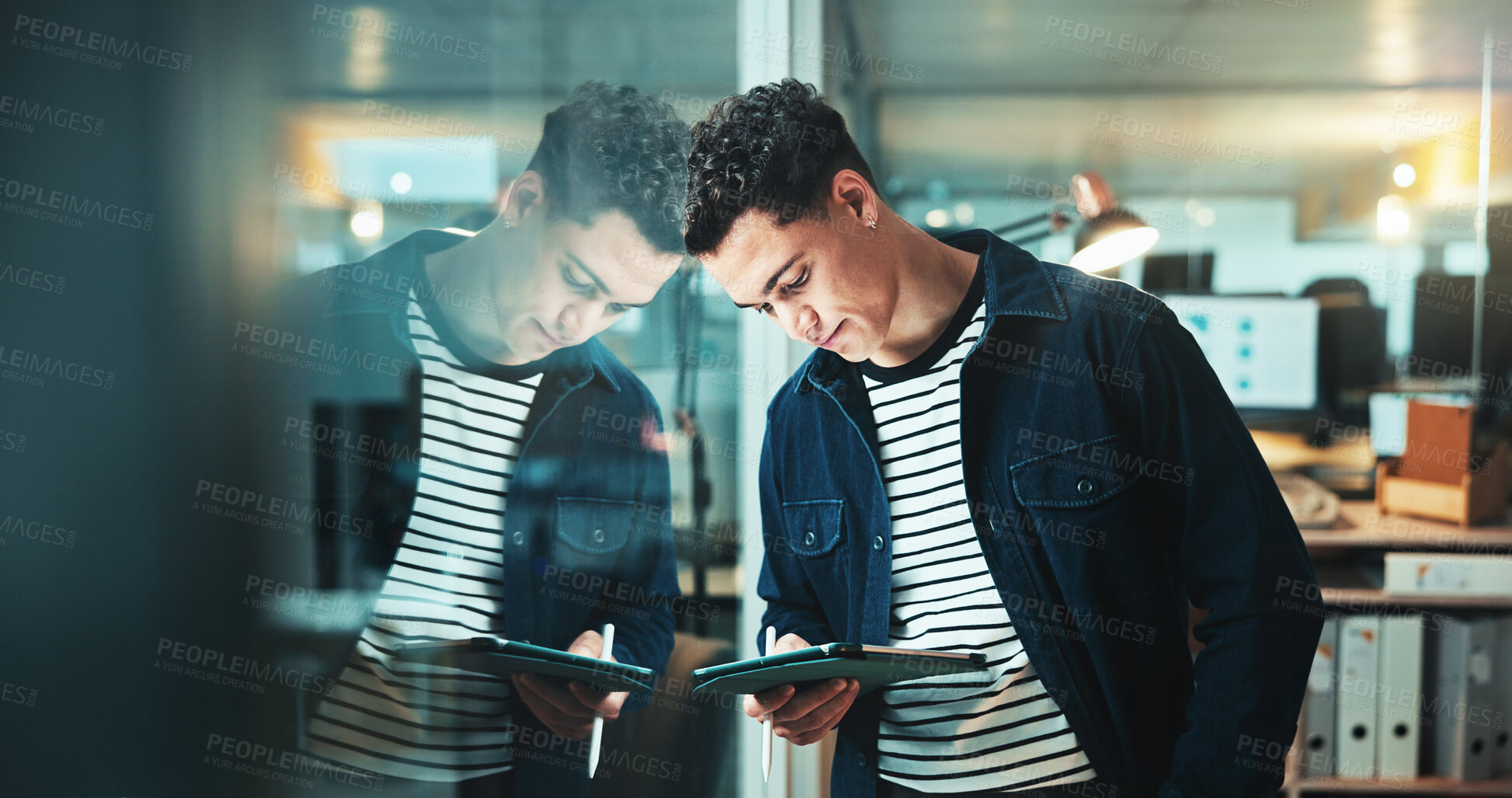 Buy stock photo Man, tablet and project by glass at startup with planning, reflection and review at night in office. Person, digital touchscreen and app for feedback, contact and problem solving at creative agency