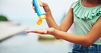 Sunscreen, hands and cream with child at swimming pool for uv rays protection, spf bottle and summer vacation. Sunblock lotion, dermatology product and closeup with kid at holiday resort for skincare