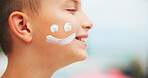 Happy boy, face cream and skincare with moisturizer for SPF, UV protection or sunscreen in nature. Profile, child or kid with smile, emoji or creme for sun lotion, holiday or outdoor summer vacation