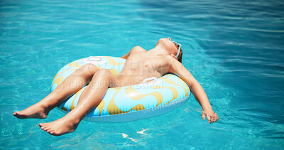 Buy stock photo Child, swimming and boy floating in pool for holiday, travel or outdoor vacation for tanning. Paradise, relax and male kid sunbathing in water at lodge, hotel or resort on summer break in Miami