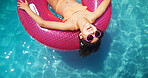 Happy girl, relax or sunglasses with inflatable above in swimming pool for summer holiday or vacation at luxury resort. Top view, child or kid with smile or comfort on floating toy for fun in sun