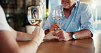 Wine, holding hands and senior couple in home, partnership celebration and love on valentines day. Romance, affection and loyalty to spouse in relationship, trust and glasses of alcohol for date