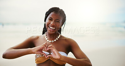 Buy stock photo Happy, black woman and portrait with heart hands on beach for summer vacation, love or support in nature. Face, female person or tourist with smile, emoji or shape for holiday on ocean coast at sea