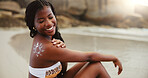 Beach, smile and black woman with sunscreen for skincare, back protection and body care for beauty. Ocean, sun cream and African girl with spf cosmetics for health and holiday, travel or adventure