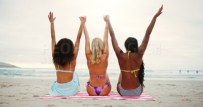 Buy stock photo Women, friends and holding hands by ocean for freedom, outdoor adventure and happiness on summer vacation. Beach, back and group together with seaside fun, united and bonding on holiday for weekend