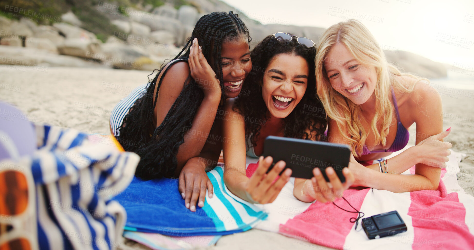 Buy stock photo Happy women, friends and relax with tablet on beach for fun entertainment, social media or laughing in nature. Female people, group or smile with technology on ocean coast for online streaming by sea