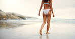 Walking, beach and back of woman in bikini at ocean for summer vacation, travel and adventure. Relax, nature and person with waves, sea and water for holiday, tropical getaway and weekend in swimwear