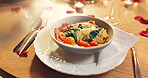 Love, food and meal with romance, bowl and ingredients with candlelight, gratitude and Valentines day. Empty, utensils and kindness with plate, rose petals or celebration for anniversary or nutrition