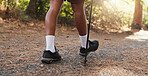 Legs, person and hiking with walking stick of backpacking, travel adventure and fitness in environment. Active, gear and balance support of trekking journey in woods, path and sightseeing on vacation