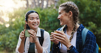 Buy stock photo Happy, coffee and hiking with friends in nature for lunch break, trekking adventure and park conservation. Drink conversation and environment with women in forest for tea, travel and peace together