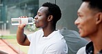 Sports athlete, hydration and man drinking water for thirst, tennis practice break or liquid refreshment. Healthy, people or mineral drink on court for workout recovery, body detox or cardio training