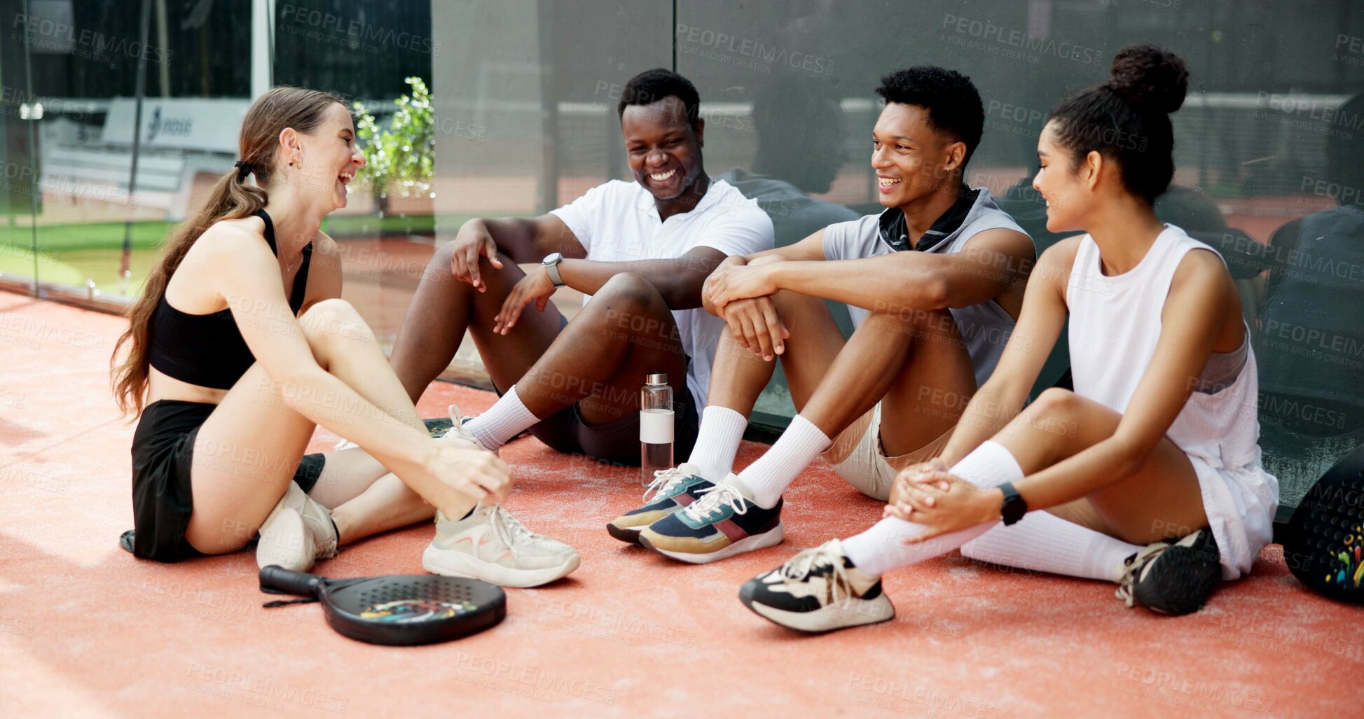 Buy stock photo Tennis, sports or team break on court with resting, funny conversation or match practice. Padel, happy friends or laughing at fitness training for tournament support or bonding together after workout