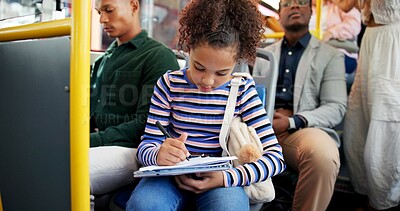 Buy stock photo Little girl, writing and bus with book for homework, assignmment or travel to school in city. Child, kid or young student with notebook in public transportation for assessment, project or learning
