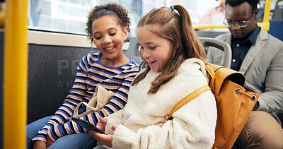 Buy stock photo Children, students and travel on bus with phone for watching videos, online cartoon and educational game. Happy friends, girls and trip on public transport for morning commute and school destination