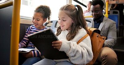 Buy stock photo Travel, children and writing in book on bus for homework assessment, studying or educational project. Friends, girls and riding on public transport with exam learning, school destination or commuting