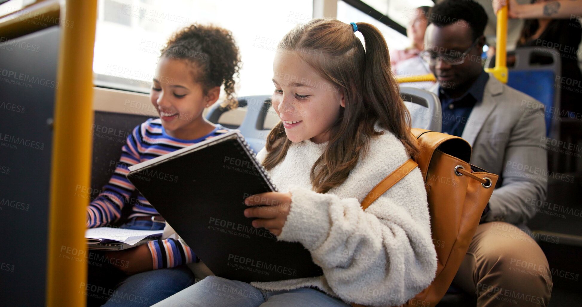 Buy stock photo Travel, children and writing in book on bus for homework assessment, studying or educational project. Friends, girls and riding on public transport with exam learning, school destination or commuting