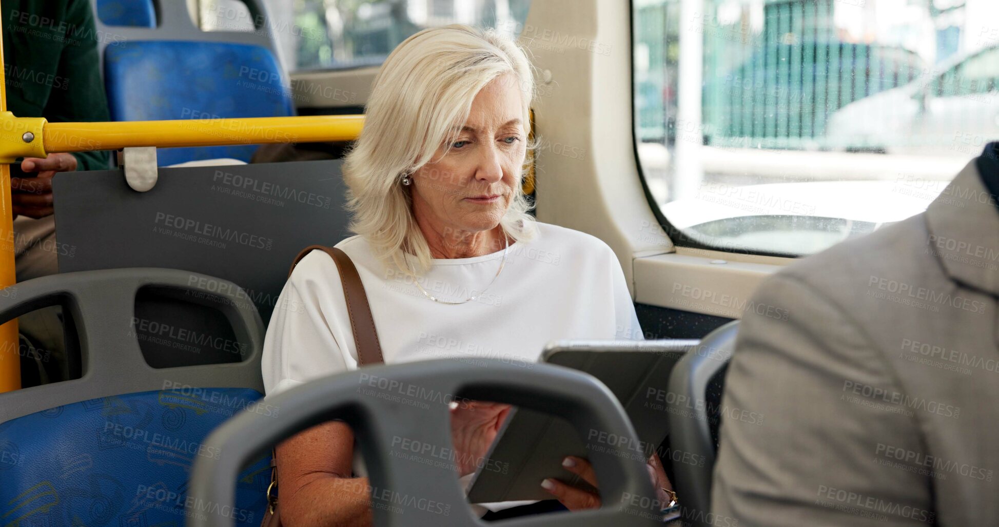 Buy stock photo Mature woman, reading and bus with tablet for local commute, ebook or travel in city. Female person, tourist or online book with technology in public transport for entertainment, story or journey