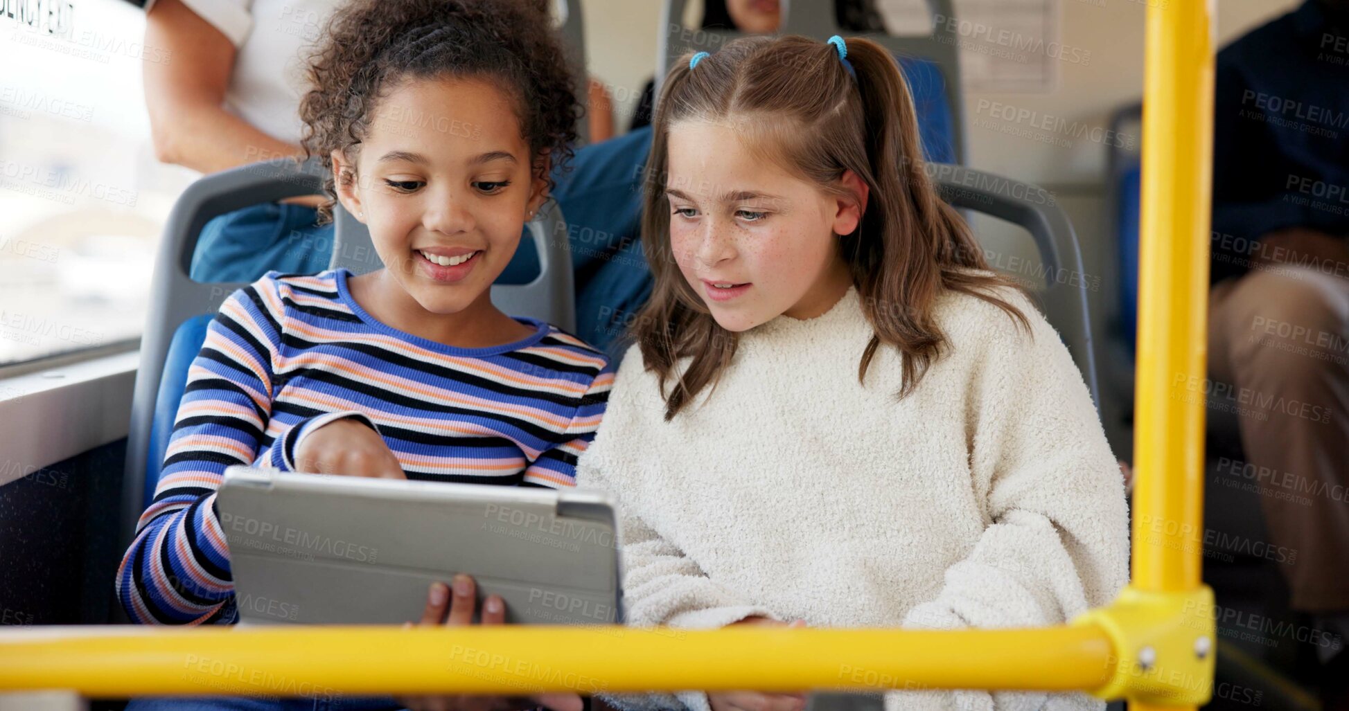 Buy stock photo Happy girls, school bus or reading with tablet for learning, education or entertainment in public transport. Children, kids or students with smile on technology in vehicle for travel, journey or trip