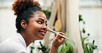 Happy woman, mirror and beauty with makeup brush for cosmetics or morning in bathroom at home. Female person, face or applying foundation with smile or reflection for cosmetology or facial at house