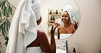 Mirror, cream and woman in bathroom, skincare and home with cosmetics, glow and wellness. Apartment, happy person and girl with healthy skin, morning and reflection with lotion, shine and towels 