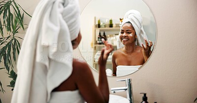Buy stock photo Mirror, cream and woman in bathroom, skincare and home with cosmetics, glow and wellness. Apartment, happy person and girl with healthy skin, morning and reflection with lotion, shine and towels 