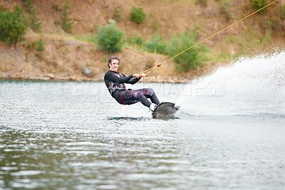 Buy stock photo Nature, wakeboarding and adventure, man on lake with outdoor fun, fitness and wave splash. Balance, water sports and person on river with freedom, speed and energy for surfing challenge, ski and sun.