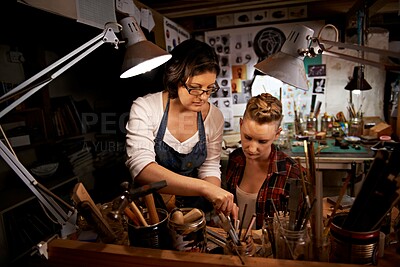 Buy stock photo Women, craft and tools in workbench for creative design, wood sculpture or handmade project at night. Artist, collaboration and manufacturing in studio with teamwork, assistance and workshop skills