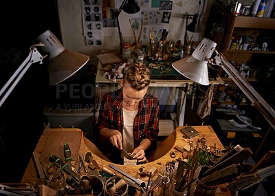 Buy stock photo Woodworking, tools and artist in workshop with creative project or above sculpture on table at night. Artisan, carpenter or person with talent for creativity in dark studio in process of carving wood
