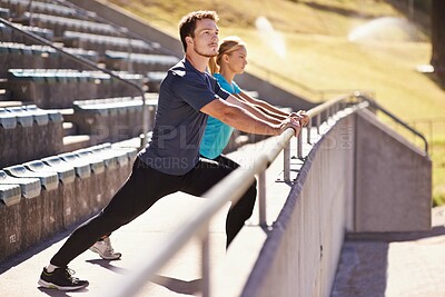 Buy stock photo Sports, legs and couple stretching in stadium for race, marathon or competition training for health. Fitness, wellness and runner athletes with warm up exercise for running cardio workout on track.