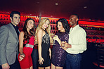 Happy people, friends and night club with drinks for dance party, fun disco or social bonding at bar. Group, celebration or event with fashion for late evening out, nightlife or entertainment at pub