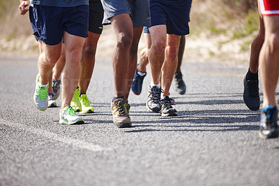 Buy stock photo People, shoes and group running in road for marathon practice, endurance training and fitness jog. Legs, low angle and athlete with race exercise for performance, sports challenge and healthy body