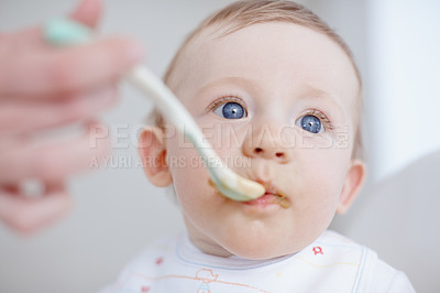 Buy stock photo Baby, parent hands and feeding in home, hungry and love to support with child development. Childcare, high chair and helping son to eat food, nutrition and healthy meal for infant diet or wellness