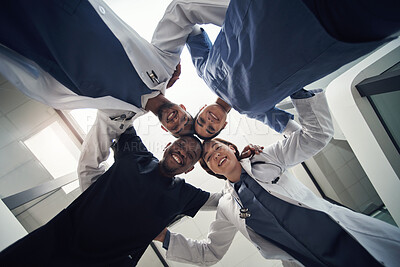 Buy stock photo Doctors, circle and below in portrait for team, diversity or solidarity in medical career at hospital. Medic group, men and women in collaboration, wellness or huddle for healthcare service at clinic