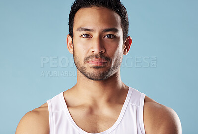 Buy stock photo Serious, portrait and skincare for man, studio and cosmetics for glow of skin, fitness and confident. Blue background, shine and treatment for person with face, dermatology or grooming in morning