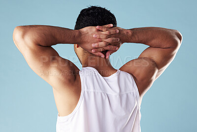 Buy stock photo Back, fitness and muscular with man in studio for exercise, training or workout routine. Health, tank top or wellness and model with hands behind head on blue background for challenge or strength