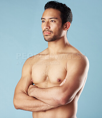 Buy stock photo Man, arms crossed and wellness with muscle in studio, reflection and results with healthy body by blue background. Indian person, bodybuilder and change for growth, strong or shirtless with self care