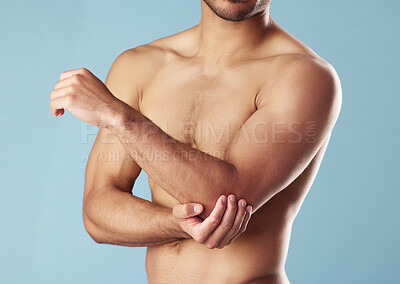 Buy stock photo Fitness, man and elbow injury in studio for joint problem, workout accident and discomfort. Athlete, topless or arm muscle tension with inflammation, fibromyalgia and exercise pain on blue background