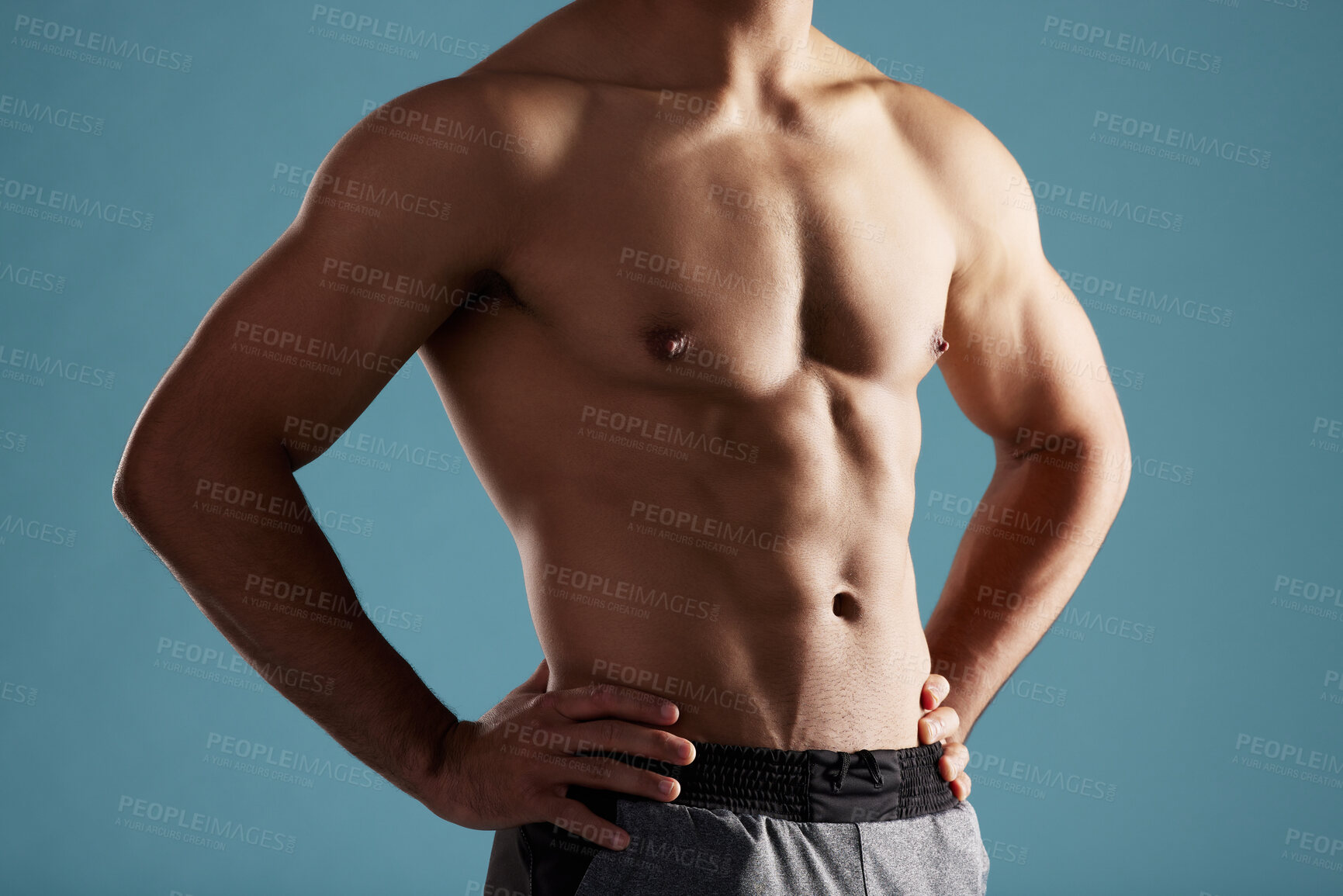 Buy stock photo Closeup, shirtless and man in studio, muscular and fitness on blue background. Person, healthy physique and model with pecs, confidence and workout with training, bodybuilder and results for exercise