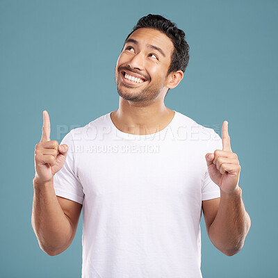 Buy stock photo Happy, man and pointing direction in studio of presentation, announcement news and information. Smile, male person and hand gesture of coming soon, sign up timeline and opportunity on blue background