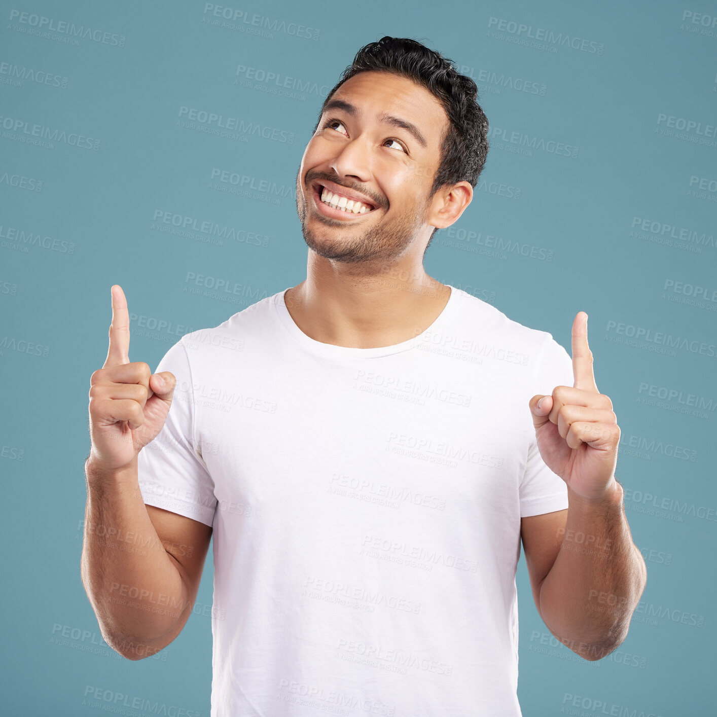 Buy stock photo Happy, man and pointing direction in studio of presentation, announcement news and information. Smile, male person and hand gesture of coming soon, sign up timeline and opportunity on blue background