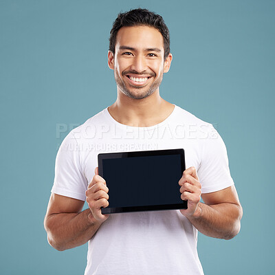 Studio, man and portrait with tablet screen for advertising, app development and product marketing. Happiness, salesperson or web designer with technology for branding, promotion and blue background