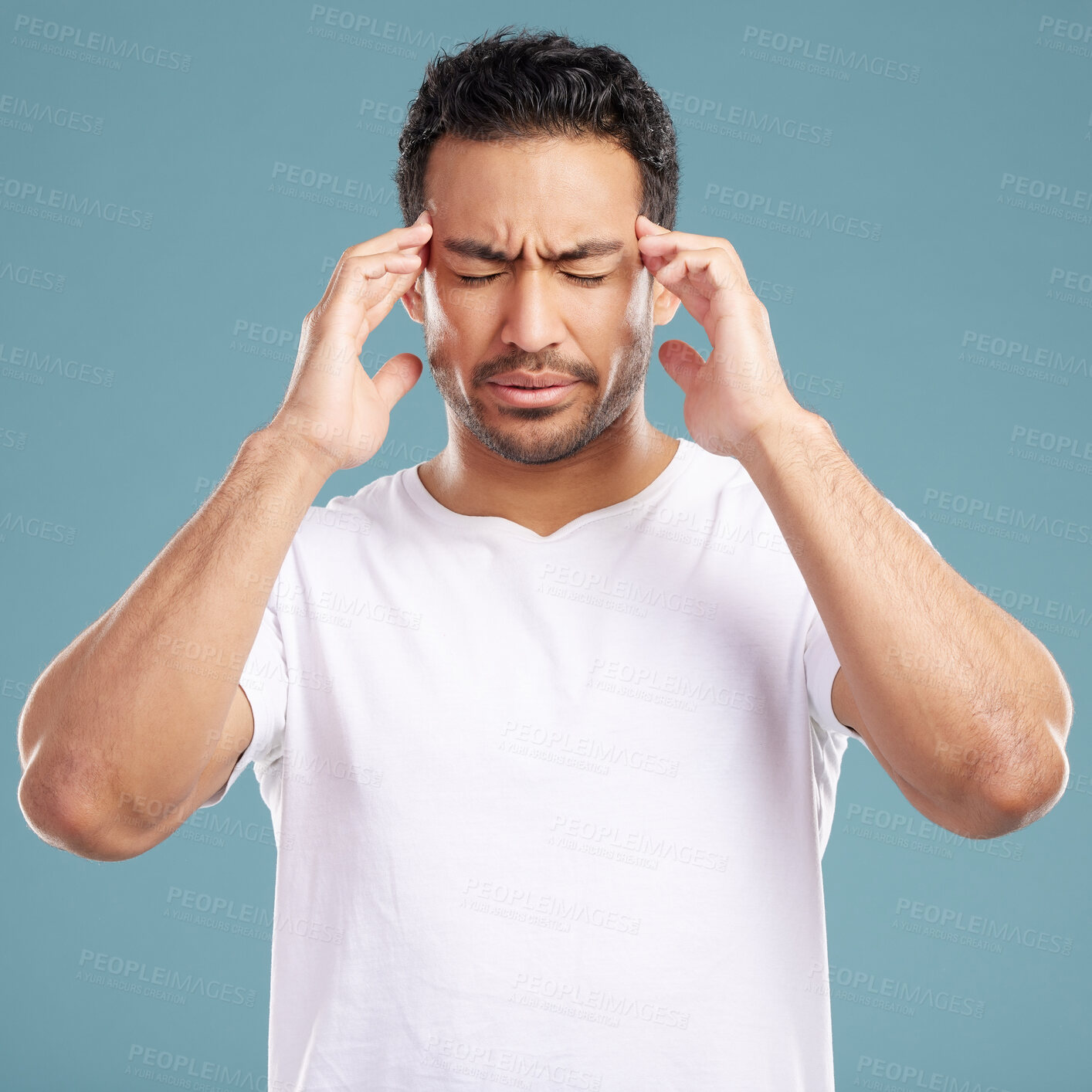 Buy stock photo Headache, stress and man in studio with anxiety, burnout or frustrated by brain fog on blue background. Vertigo, face and male model with temple massage for pain, migraine or tension or strain