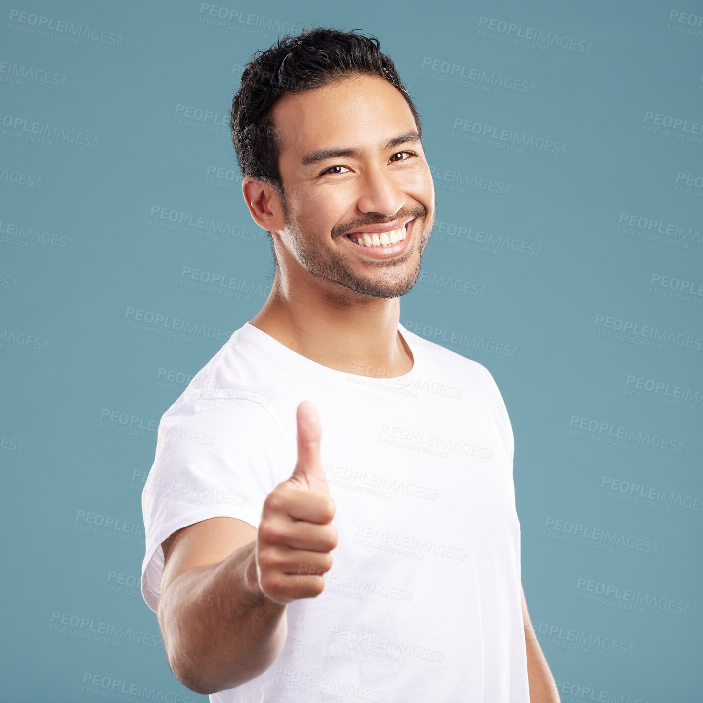 Buy stock photo Portrait, happy and man with thumbs up in studio for yes, thank you sign and feedback on news. Smile, male person and hand gesture of agreement, like opportunity and celebrate vote on blue background